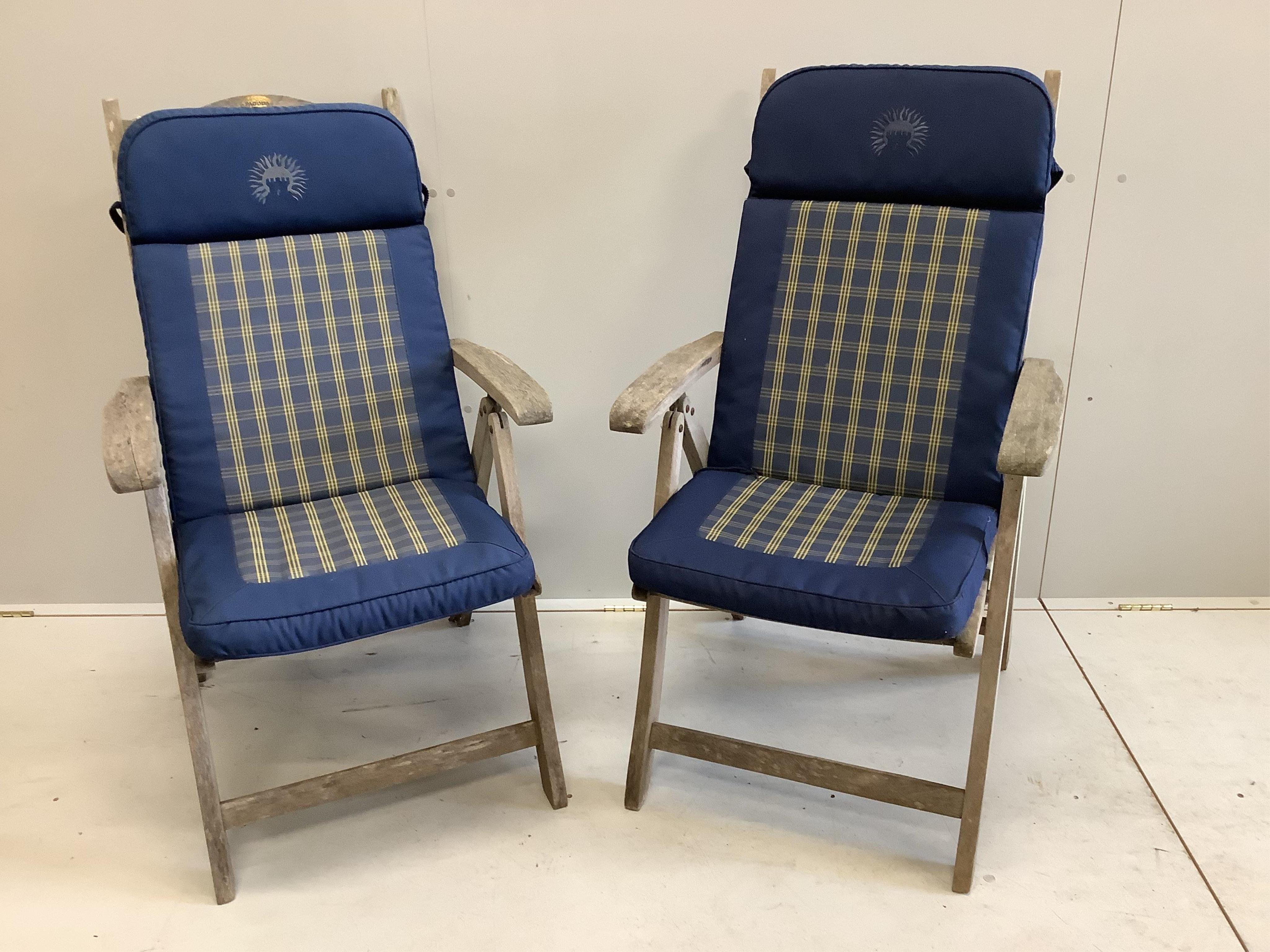 A pair of 'Pagoda' teak folding garden chairs and cushions. Condition - weathered